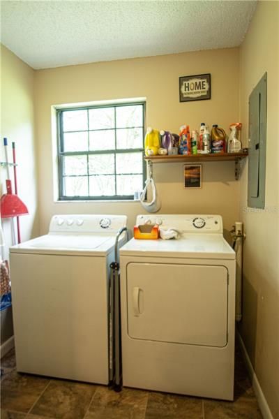Interior laundry room with tile flooring
