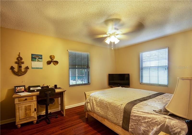 Guest bedroom with wood floors