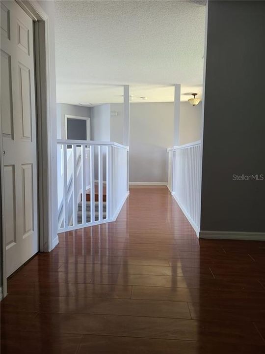 3rd bathroom door on the left.  Hallway from Loft to the stairs and great room.