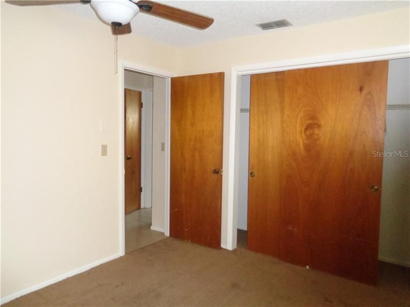 Guest Bedroom has ceiling fan and wall closet