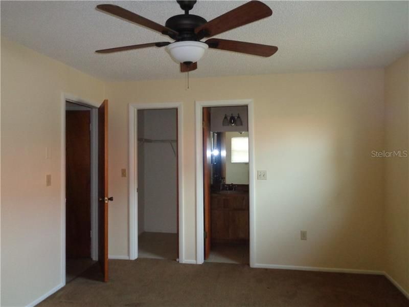 Master Bedroom has ceiling fan,  walk in closet and bathroom with step in shower