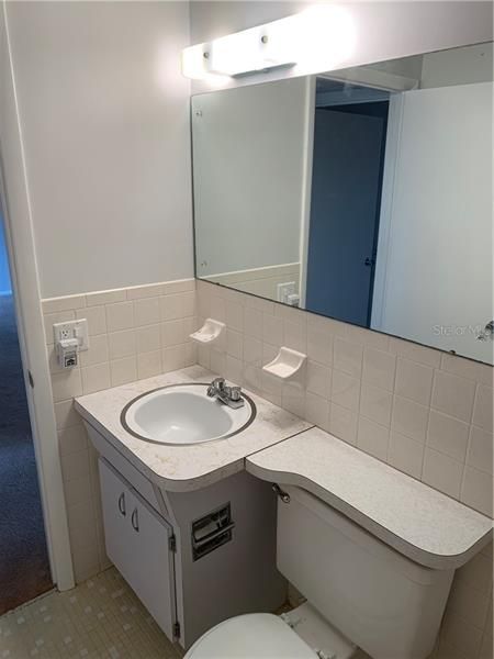 Guest bathroom has ceramic tile flooring.