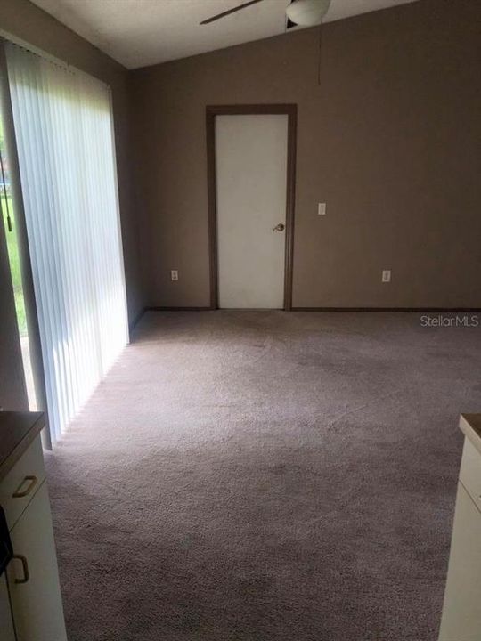 View from Kitchen to Dining Area & Garage Entry with Washer/Dryer