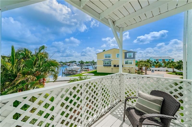 Walk on to balcony from living room with picturesque coastal water views.