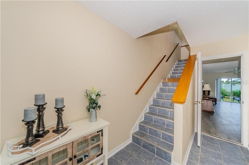 Enter into cozy foyer. Large bonus room which comes with portable AC/Heater with beautiful wood grain ceramic tile.