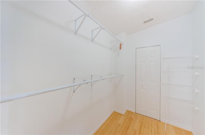 Master suite has a spacious walk in closet. Door into utility room where AC is housed.