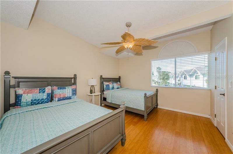 Spacious 2nd bedroom has large window, high ceilings, walk in closet shown to the right.