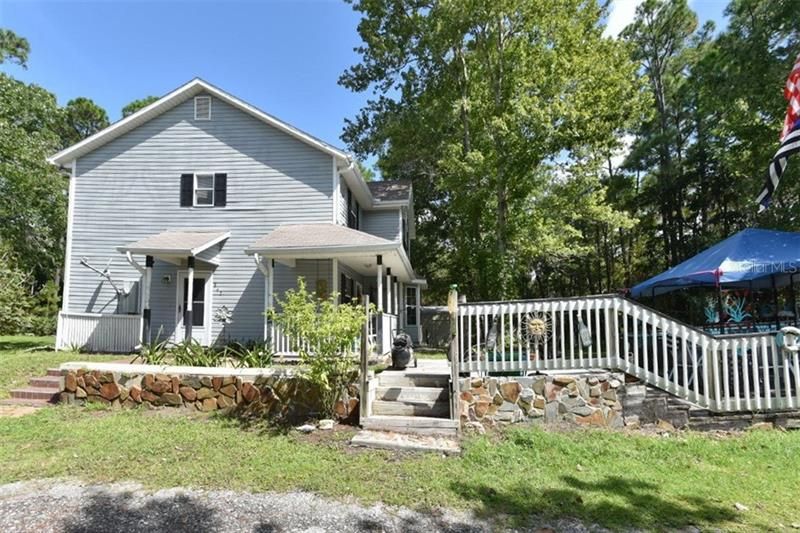 Side view of home with stone accented deck and canopy!