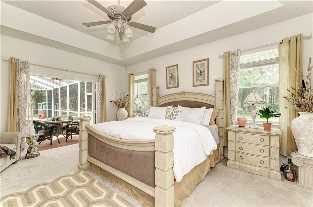 Master Bedroom opens to the pool and surrounded by the private woods. 18.4'x14.3'