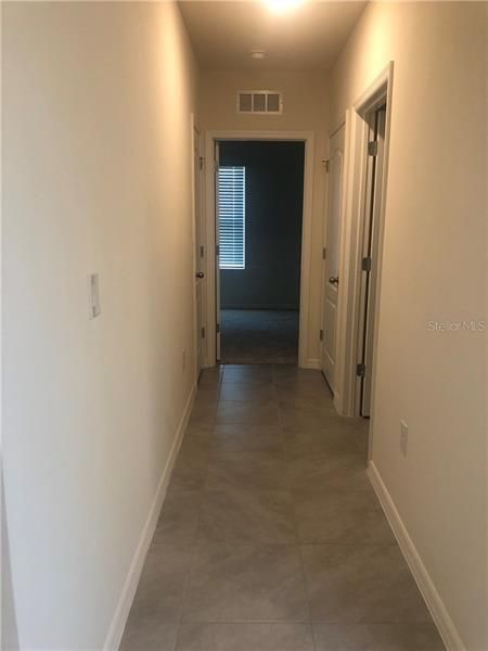 Hallway to guest bath and 3rd bedroom