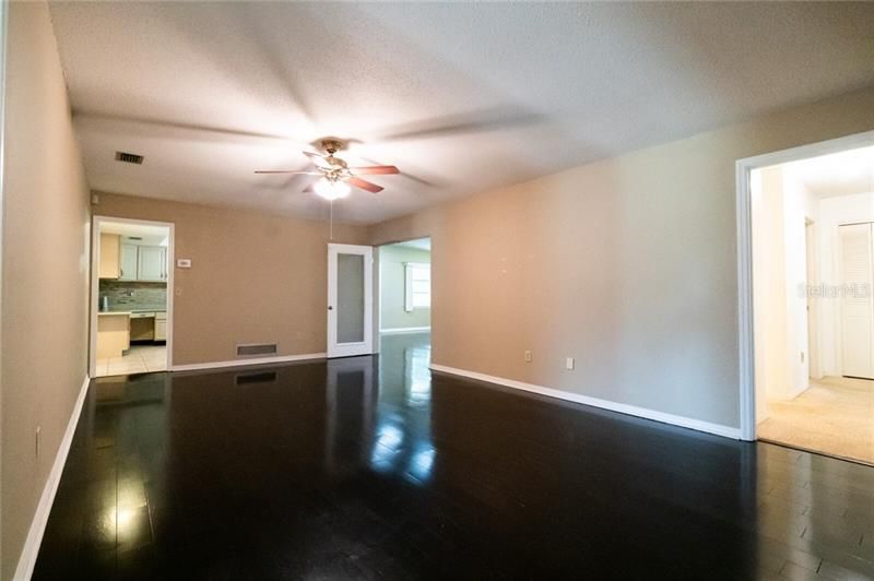 Family Room right off kitchen featuring wood floors and ceiling fan