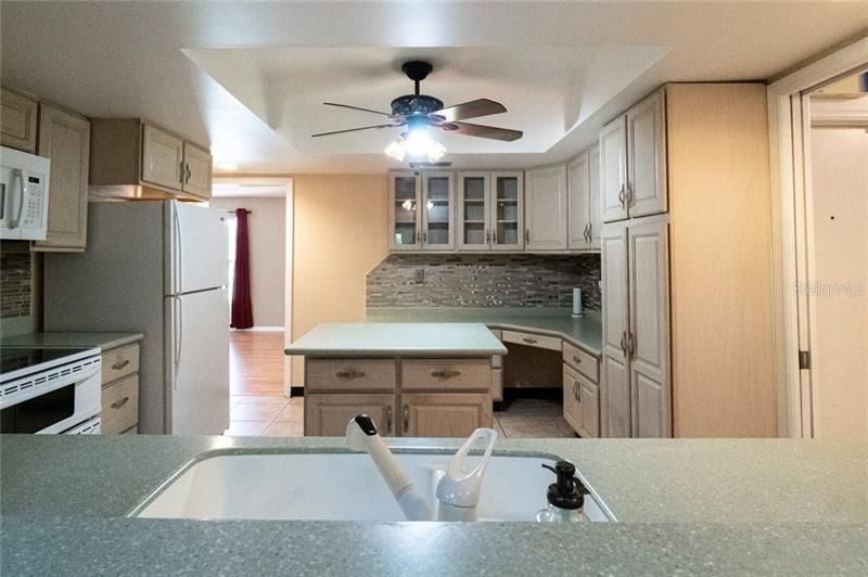 Kitchen featuring island, pocket door to close off laundry area