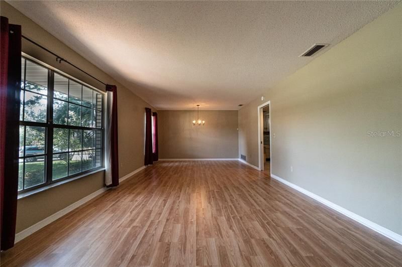 Huge Living/Dining room featuring laminate floors