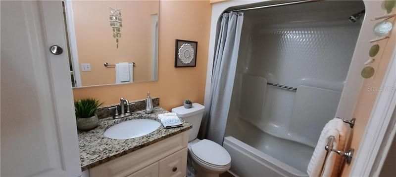 hall bath with new vanity granite sink faucet and new toilet