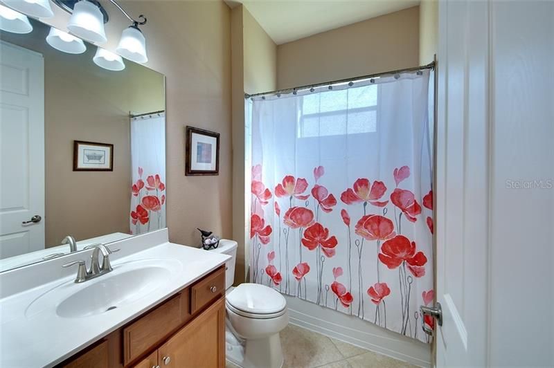 Guest Bathroom offers shower/tub, linen closet and natural light