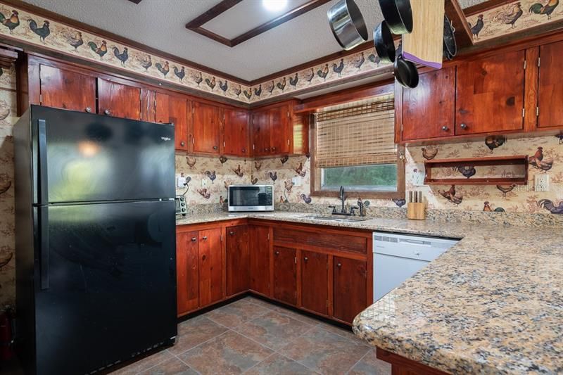 Large country kitchen with tile floors and oversized sink. Appliances convey.