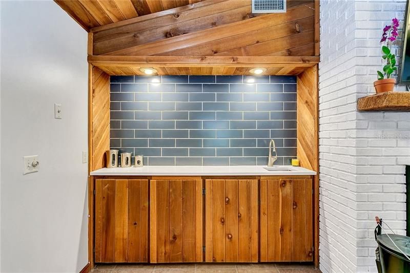 An Updated Wet Bar With Quartz Countertop and Subway Tile
