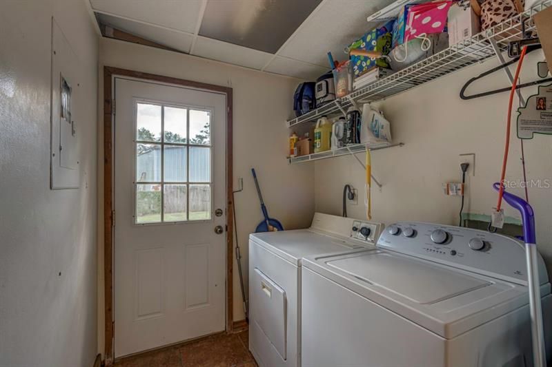 Laundry room with separate entrance to driveway