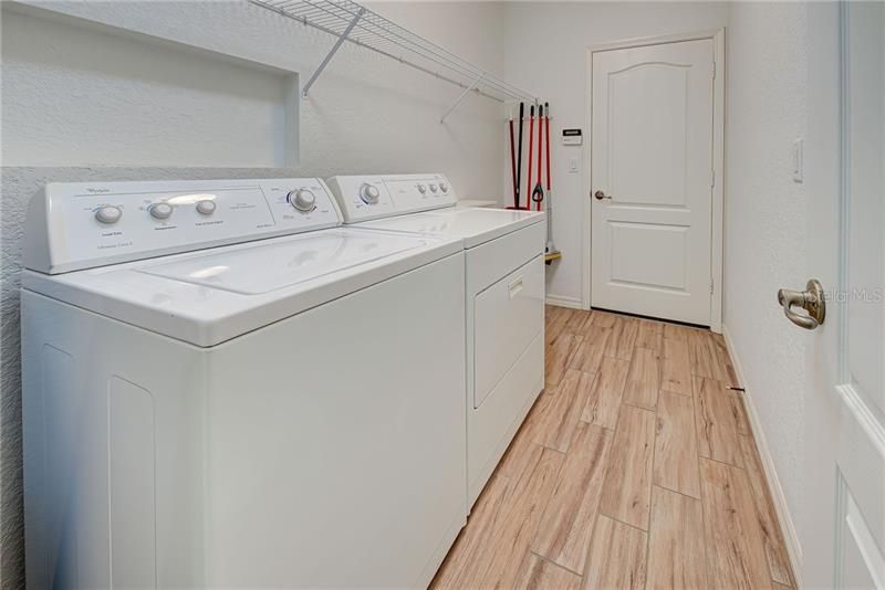 Convenient interior laundry room leads from the garage into the kitchen.