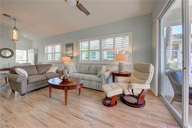 Living room has 10 foot ceilings, plantation shutters, neutral colors and most of the furniture is included...wow!