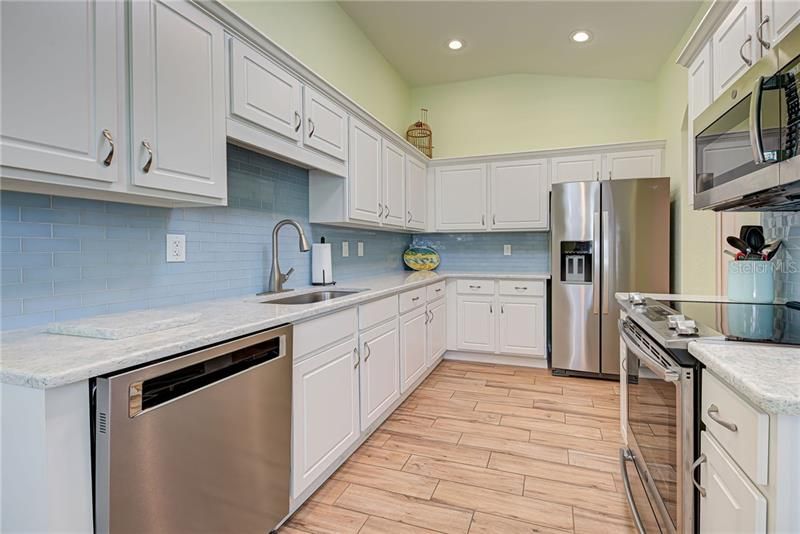 Chefs will love whipping up a meal in the remodeled kitchen with its quartz counters and glass tile backsplash.