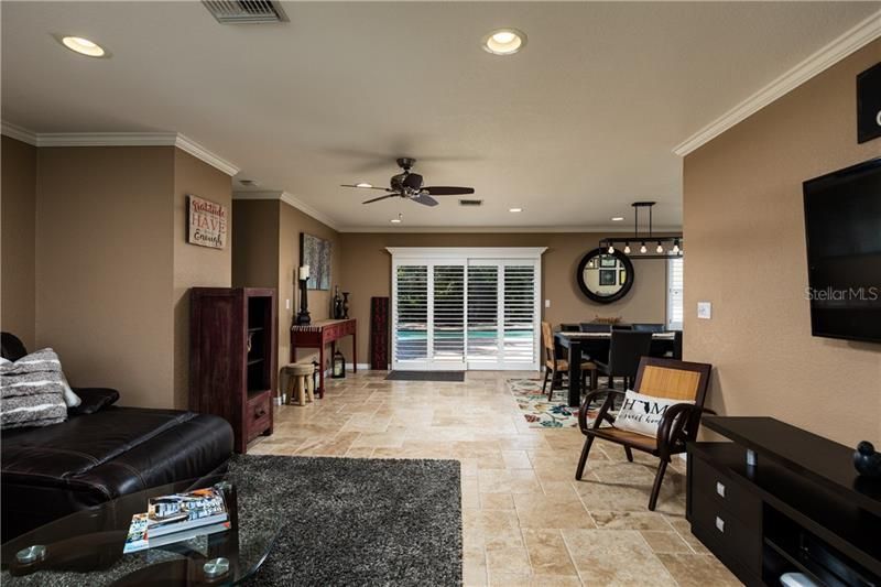 Open floor plan from living room looking through the dining area to the pool.