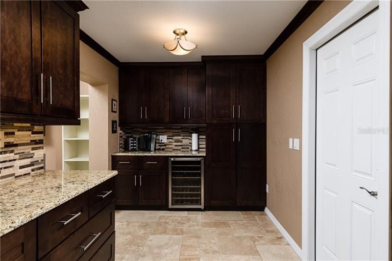 Storage, coffee bar and wine refrig. Door on the right opens to the garage. Easy for unloading the groceries. Washer and dryer are located in the garage.