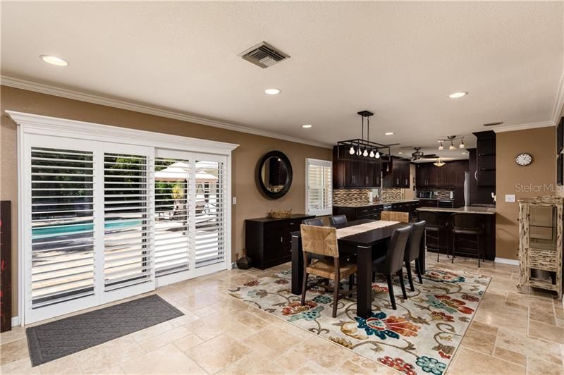 Dining area opens to the pool and patio and adjacent to the kitchen.