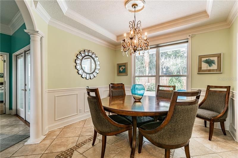 Dining Room with views of pool areas all open or can be closed by pocket doors to kitchen and family room