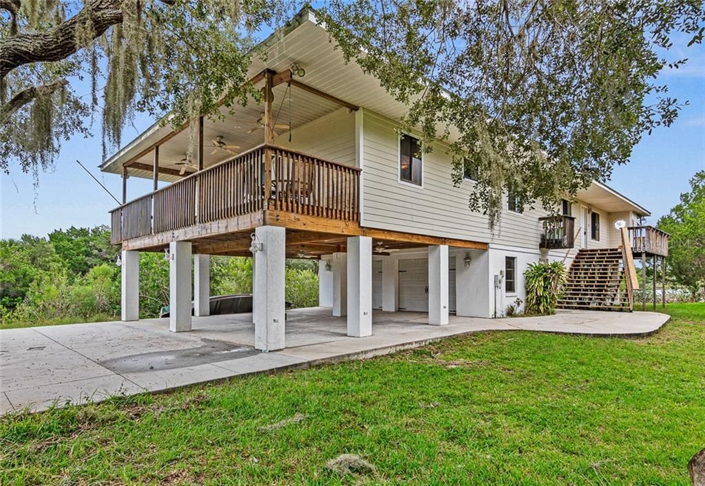 2 Car Garage and 2 Car Carport. Entry Way To Front Door Via Stairs On Right.