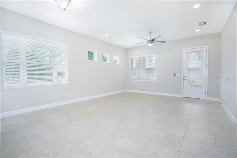 The main floor features an open concept living room, dining room, kitchen, and half bath all with beautiful ceramic tile floors.