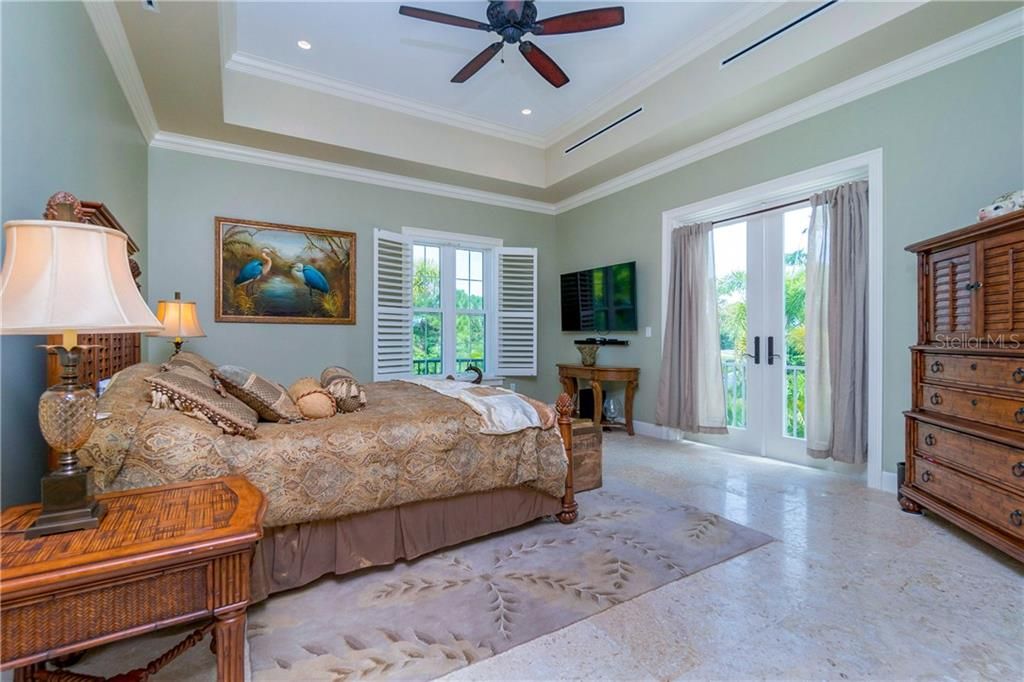 Guest bedroom suite with direct veranda access, plantation shutters & tray ceilings