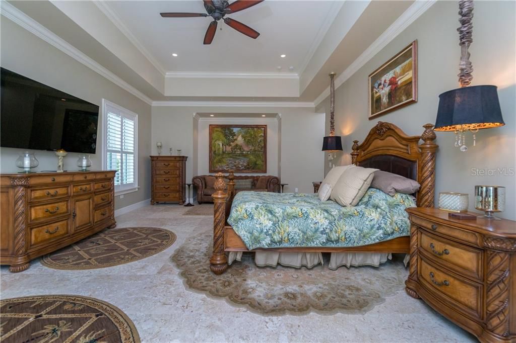Tray ceilings, crown molding, bedside chandeliers & private seating area.