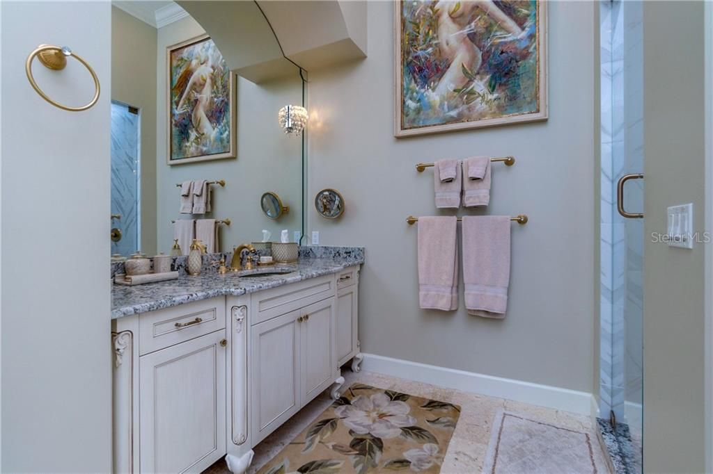One of two sink & vanity areas with full vanity to ceiling mirror