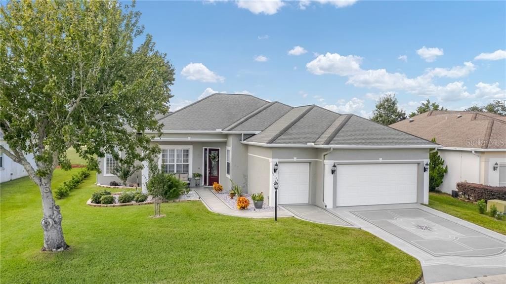 GORGEOUS Front Elevation paved driveway, 2 Car Garage + Golf Cart Garage.