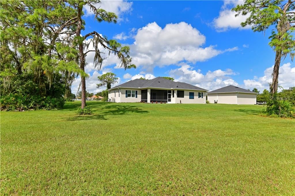 Rear view. Lots of room to add-on or just enjoy the wide open spaces.  Pool, guest house, RV garage, stable...What's YOUR pleasure?