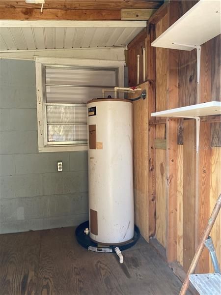 Hot water heater is located inside the shed.