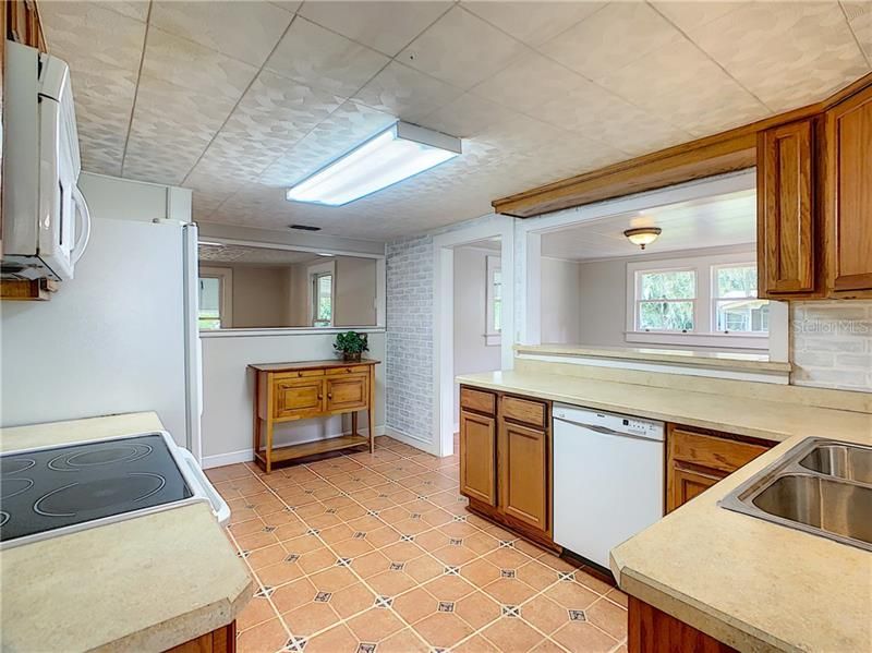 Large 9' x 13' kitchen has wood cabinets and plenty of counter work space.