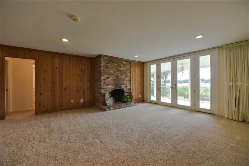 Downstairs family room features wood burning fireplace