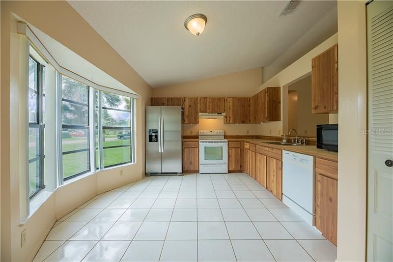 Natural light surrounds the house, especially this bay window right in your kitchen where you have a wooded view!