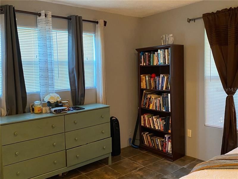 Master bedroom is roomy with tile flooring, large private bath