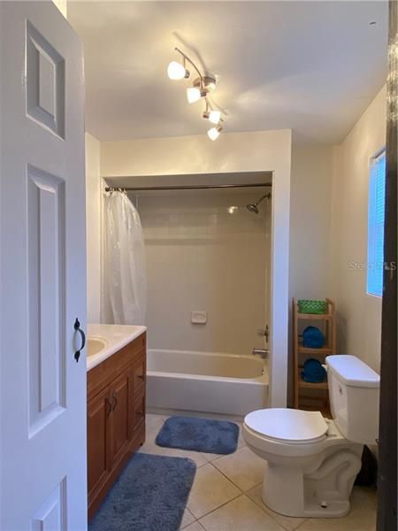 Master bath has large vanity, linen closet, tub with shower