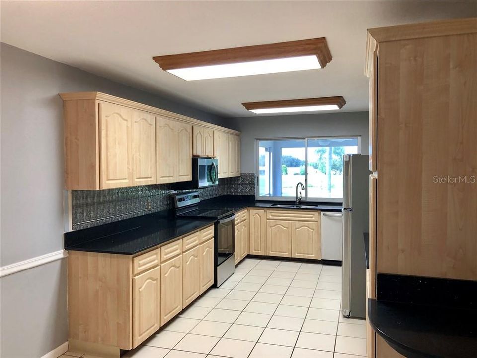 LARGE SPACIOUS KITCHEN WITH BRAND NEW APPLIANCES! PASS THROUGH WINDOW RIGHT AT THE SINK