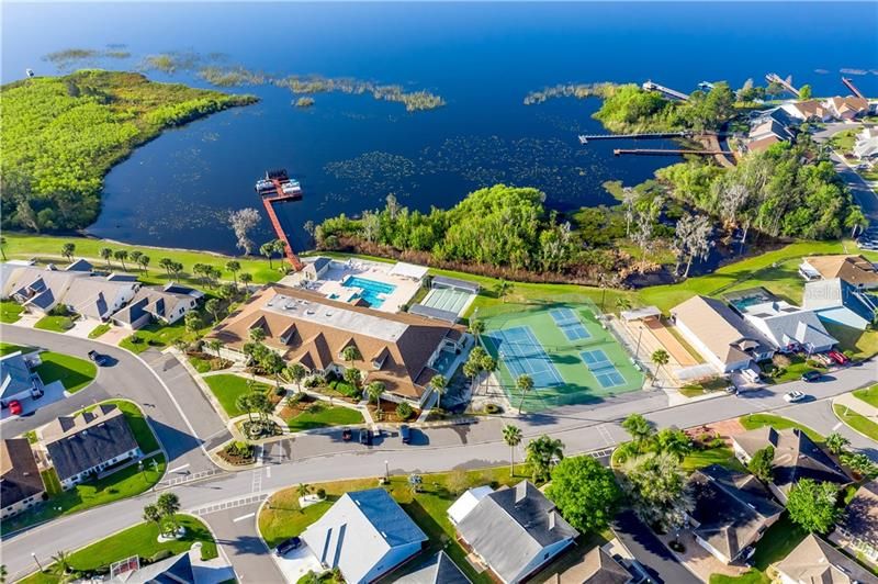 AERIAL VIEW OF CLUBHOUSE, POOL, SHUFFLEBOARD , PICKLEBALL & TENNIS COURTS AND LAKE HENRY