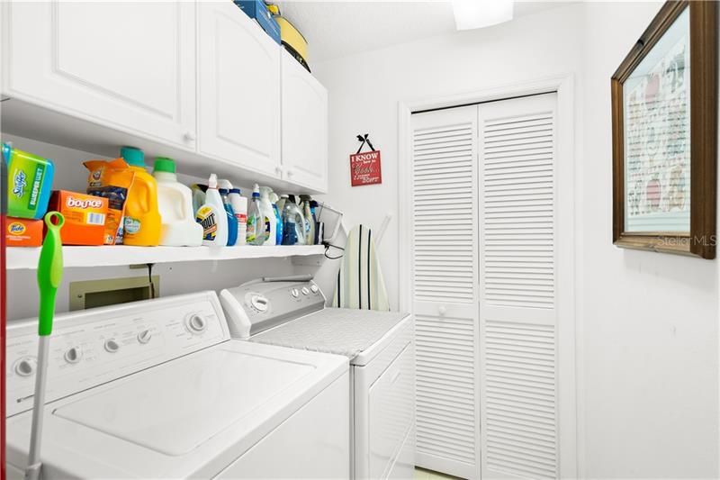 LAUNDRY ROOM. NOTE CABINETRY, SHELF  AND CLOSET