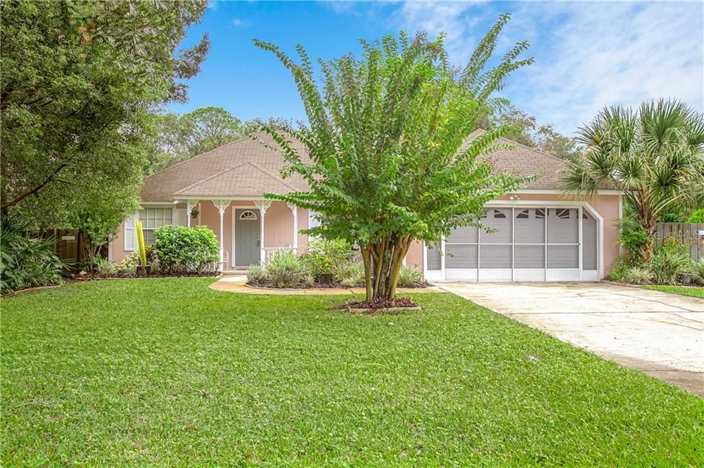 Beautifully landscaped 3/2/2 on corner lot with huge fenced back yard and many newer features.