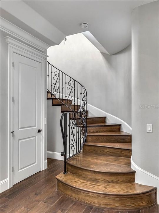 Dramatic custom staircase housed within the turret