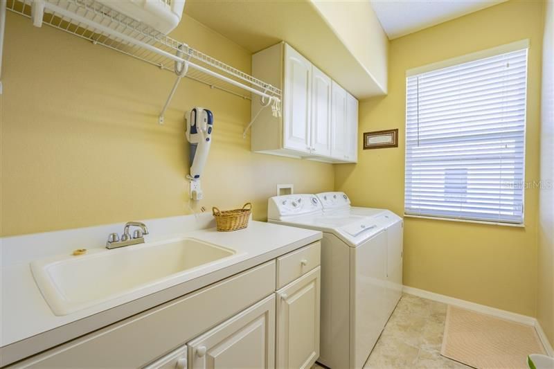 Inside laundry room with built ins and utility sink