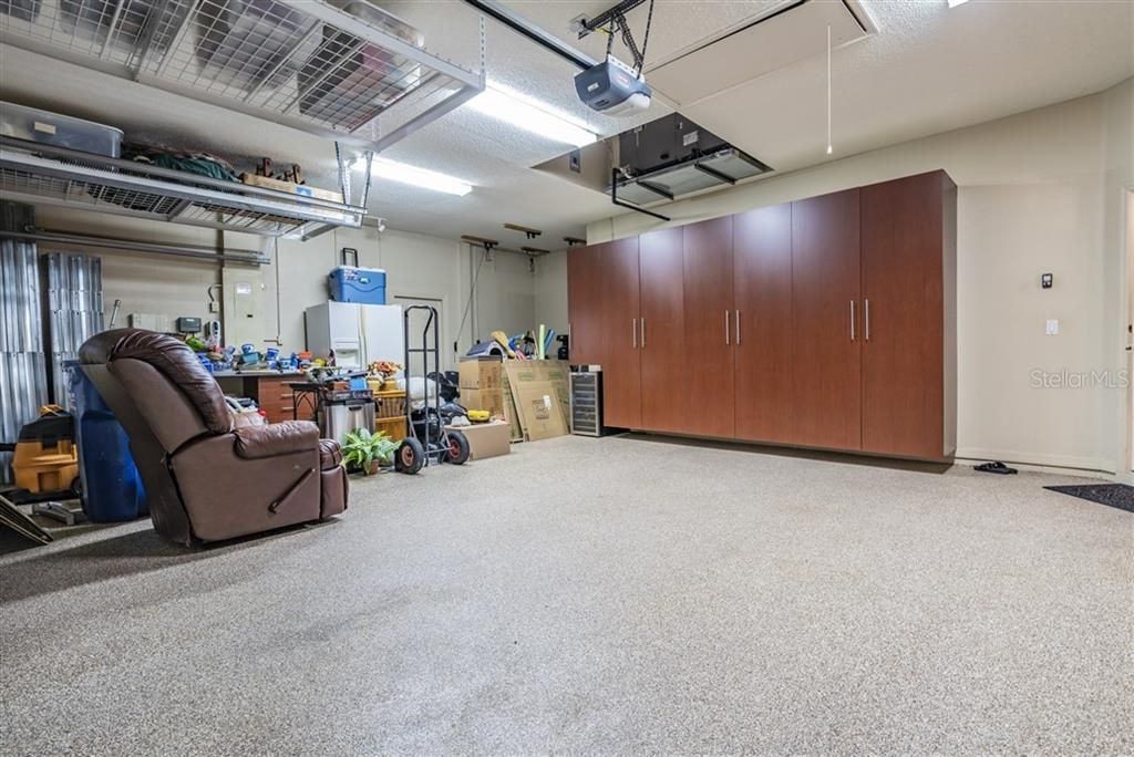 3 car garage with built-in cabinets and room for storage