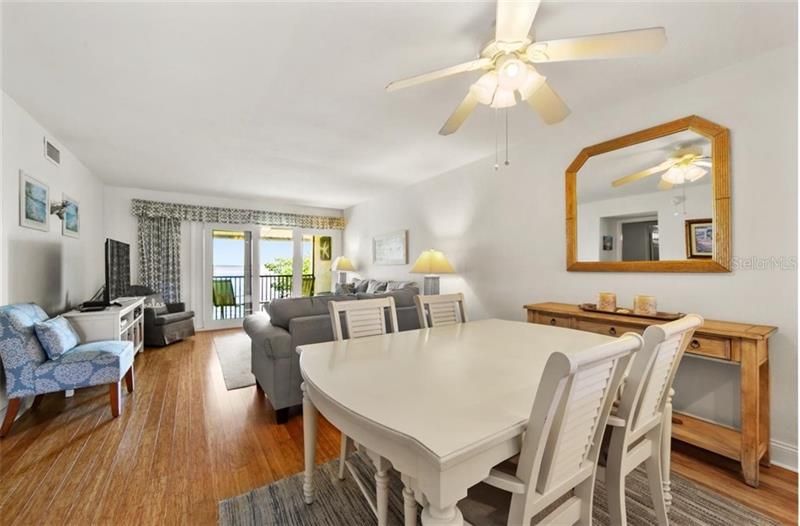 View of living room from dining room.  Sliders to lanai with bay views.